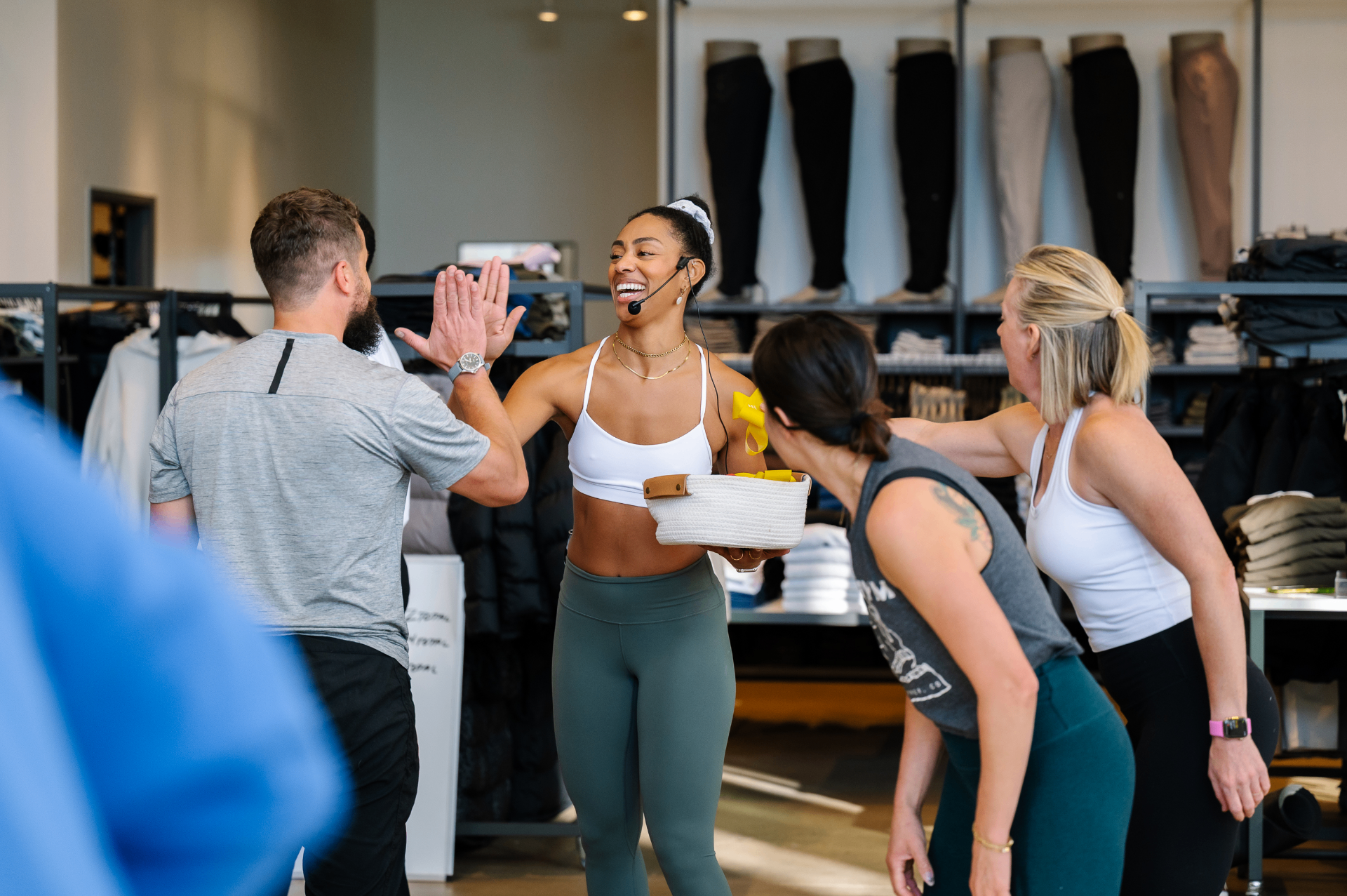 Instructor high-fiving participants during a class